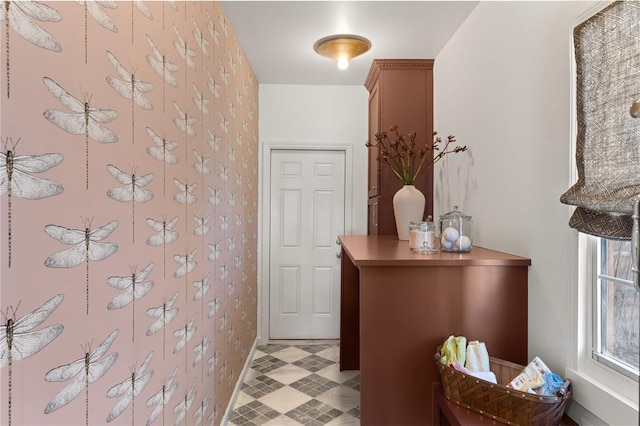 hallway with light floors and baseboards