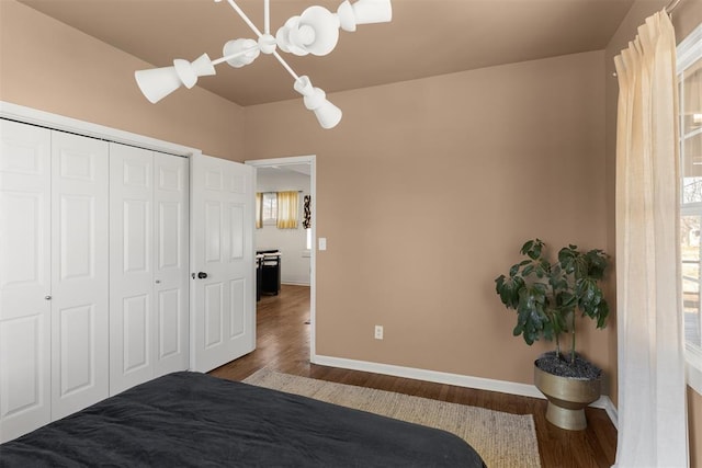 unfurnished bedroom featuring a closet, wood finished floors, and baseboards