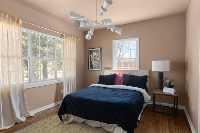 bedroom with baseboards and wood finished floors