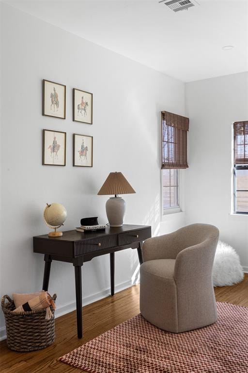 home office featuring baseboards, visible vents, and wood finished floors