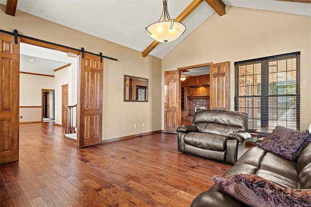 living area with high vaulted ceiling, a barn door, beam ceiling, and hardwood / wood-style flooring