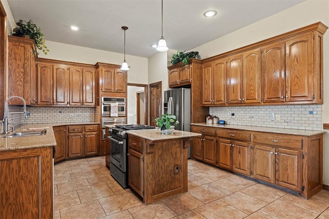 kitchen featuring stainless steel appliances, a kitchen island, a sink, and brown cabinetry