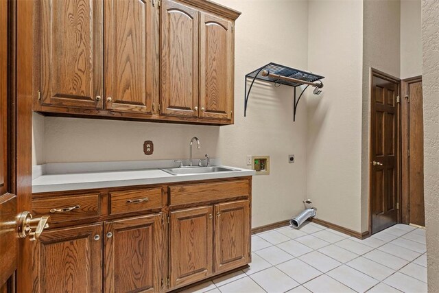 washroom featuring light tile patterned floors, hookup for a washing machine, cabinet space, a sink, and electric dryer hookup