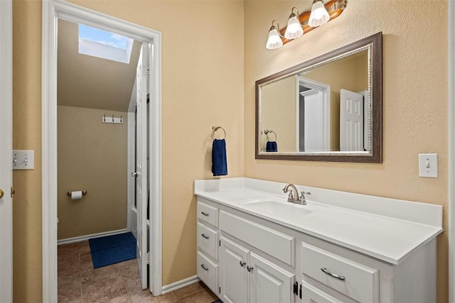 bathroom with vanity and baseboards