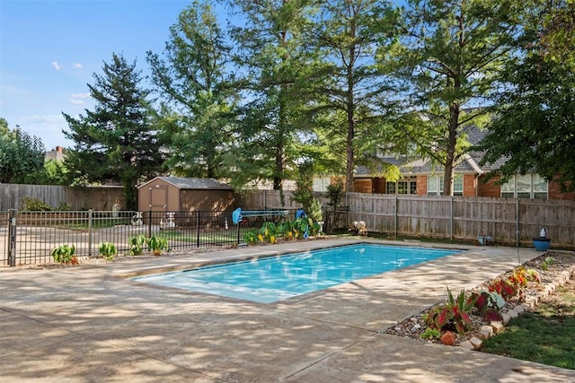 view of swimming pool featuring a storage shed, an outdoor structure, a fenced backyard, and a fenced in pool