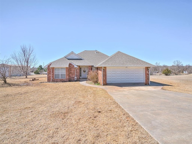 ranch-style house featuring driveway, brick siding, roof with shingles, and an attached garage