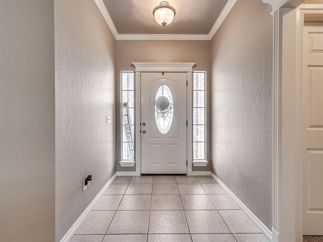 entryway with ornamental molding, a textured wall, baseboards, and light tile patterned floors