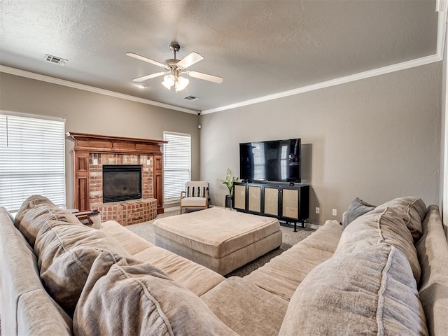 living area with carpet, visible vents, a textured ceiling, and ornamental molding