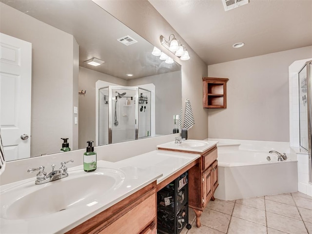 bathroom with a stall shower, visible vents, a sink, and tile patterned floors