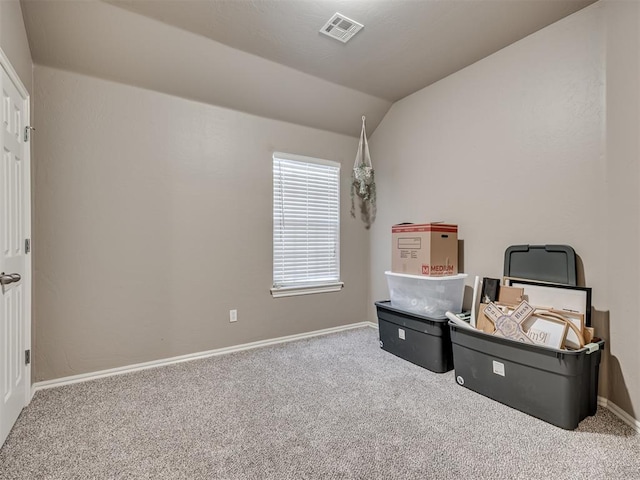 interior space with baseboards, visible vents, vaulted ceiling, and carpet flooring