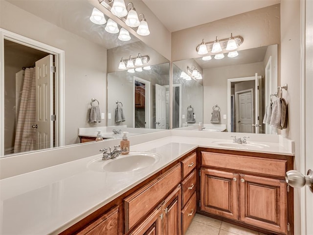 full bath with double vanity, a sink, and tile patterned floors