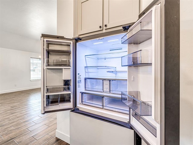 kitchen with wood finish floors and baseboards