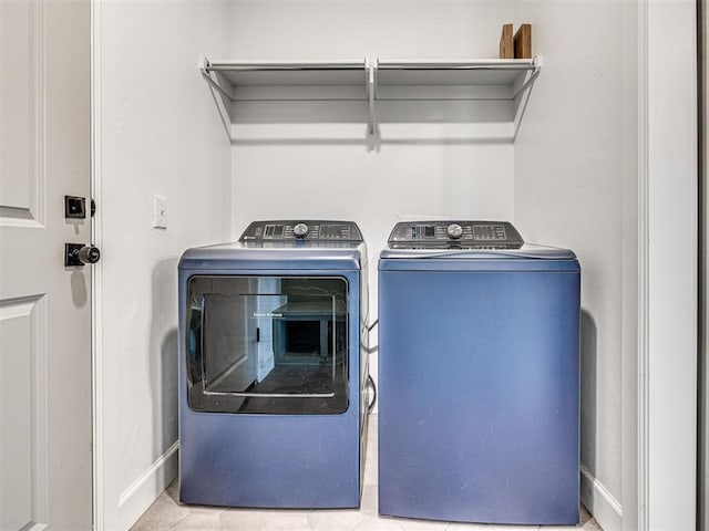 laundry room featuring laundry area, independent washer and dryer, and baseboards