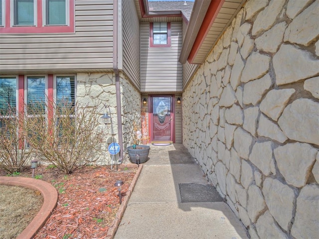 view of exterior entry featuring stone siding