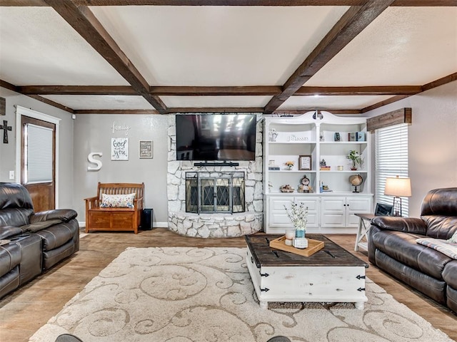 living area featuring a fireplace, light wood-style floors, coffered ceiling, beamed ceiling, and baseboards