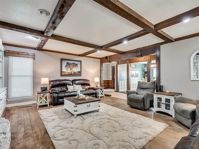 living room featuring a textured ceiling, hardwood / wood-style floors, coffered ceiling, and beam ceiling