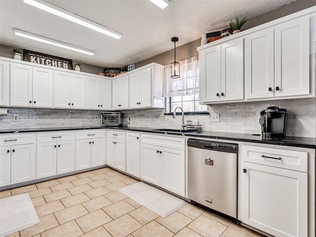 kitchen featuring a sink, dark countertops, white cabinets, and dishwasher