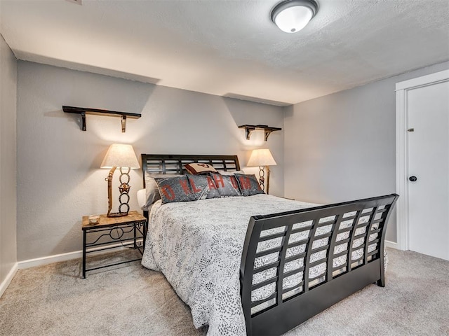 carpeted bedroom with baseboards and a textured ceiling