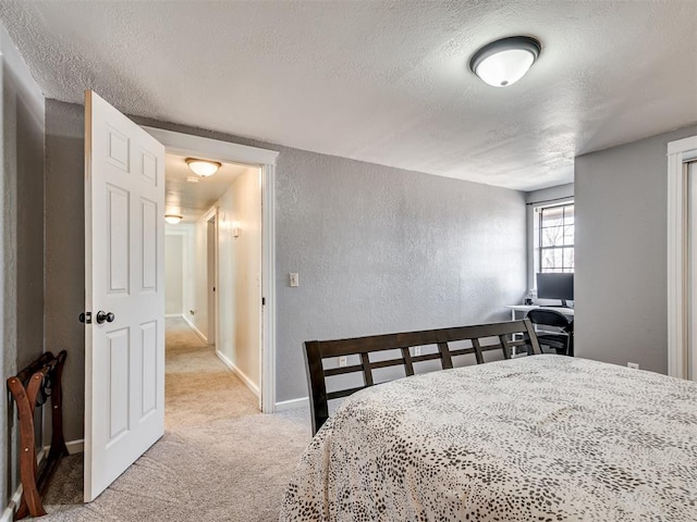 carpeted bedroom featuring baseboards, a textured ceiling, and a textured wall