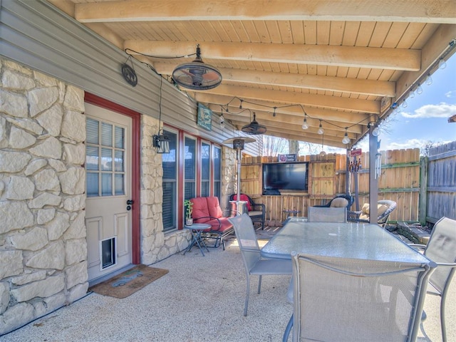 view of patio / terrace featuring ceiling fan, outdoor dining area, and fence