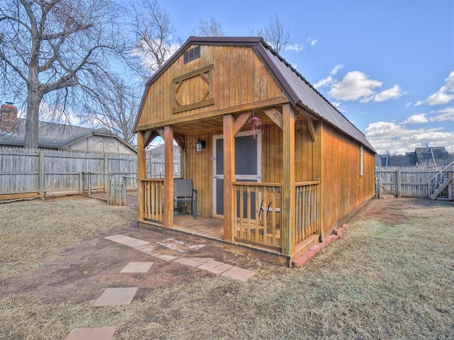 view of outbuilding with a fenced backyard and an outbuilding