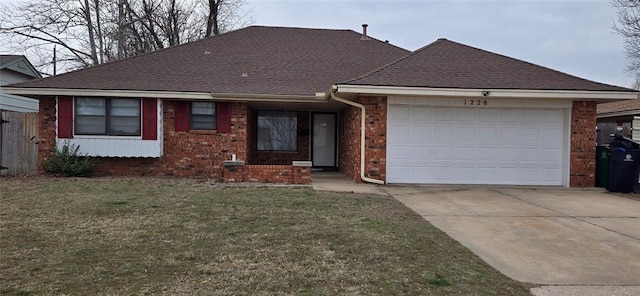 ranch-style house featuring brick siding, driveway, a front yard, and a garage