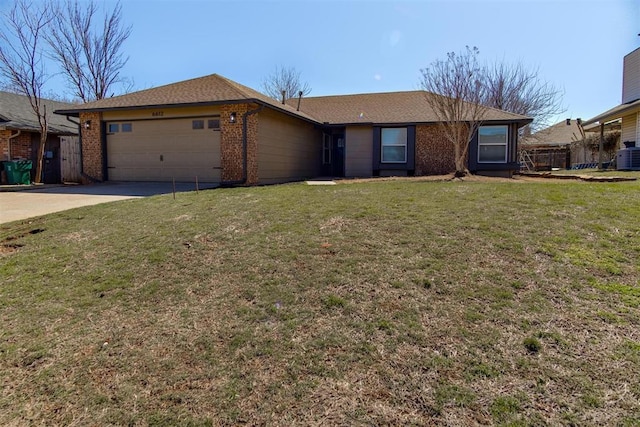 ranch-style home featuring driveway, a front yard, brick siding, and an attached garage