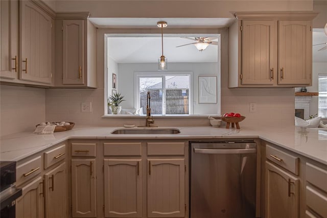 kitchen with stainless steel dishwasher, light countertops, a ceiling fan, and a sink