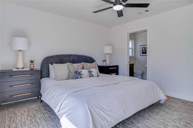 bedroom featuring visible vents, a ceiling fan, ensuite bath, carpet floors, and baseboards