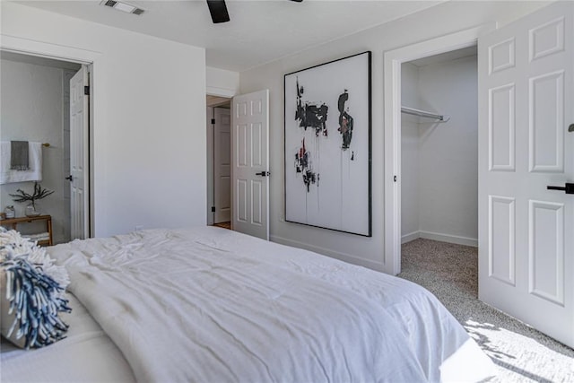 bedroom featuring visible vents, ceiling fan, a spacious closet, a closet, and carpet flooring