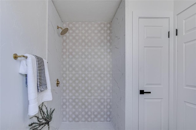 full bath with a tile shower