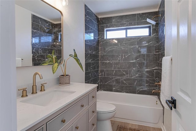 bathroom featuring toilet, vanity, and bathtub / shower combination