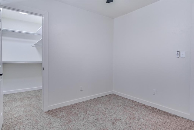 unfurnished bedroom featuring a closet, baseboards, and carpet