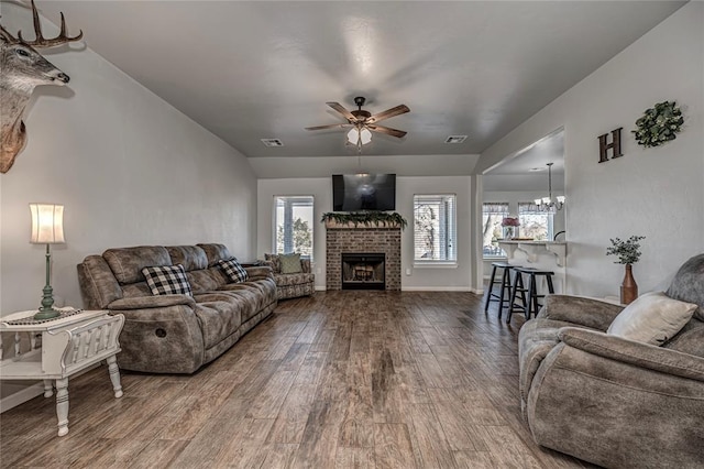 living area featuring dark wood-style floors, visible vents, and plenty of natural light