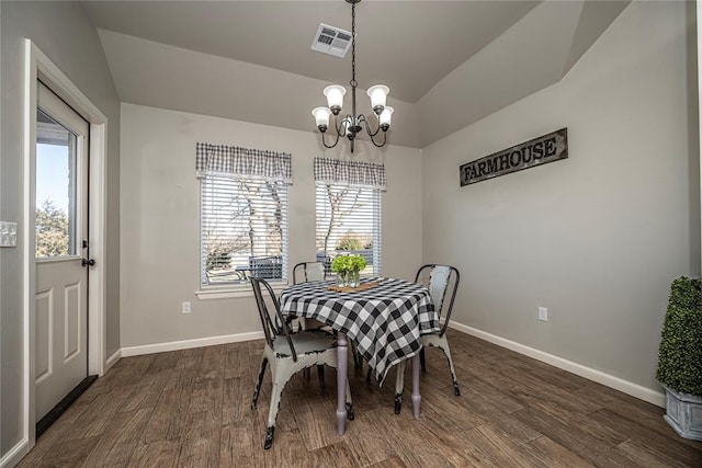 dining room featuring visible vents, baseboards, lofted ceiling, dark wood-style floors, and an inviting chandelier