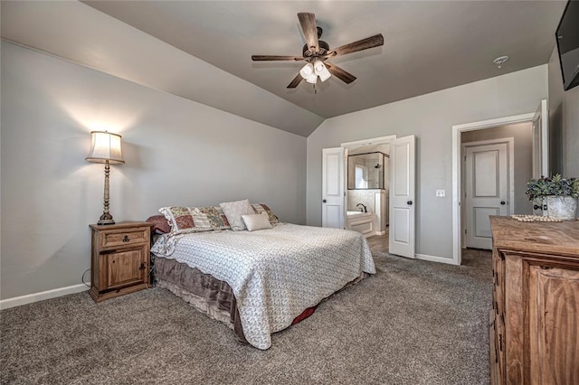 bedroom with dark carpet, ensuite bathroom, ceiling fan, vaulted ceiling, and baseboards