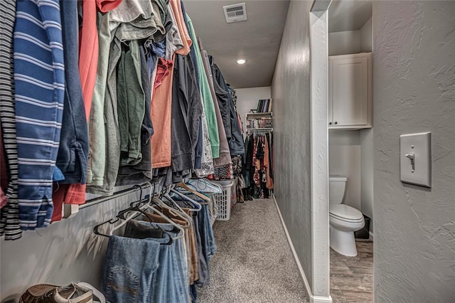 walk in closet featuring visible vents and wood finished floors