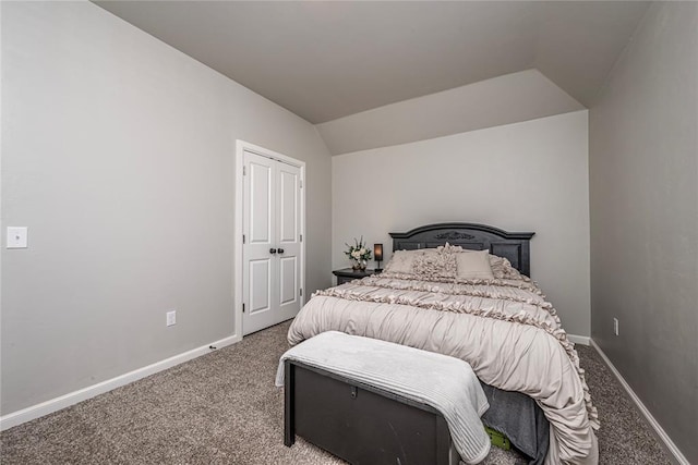 carpeted bedroom with lofted ceiling and baseboards