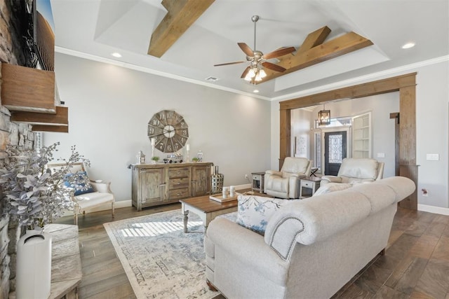 living area featuring baseboards, hardwood / wood-style floors, a tray ceiling, crown molding, and recessed lighting