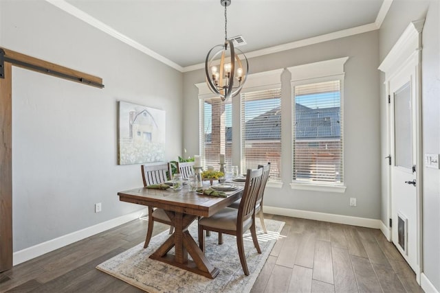 dining room featuring visible vents, crown molding, baseboards, and wood finished floors