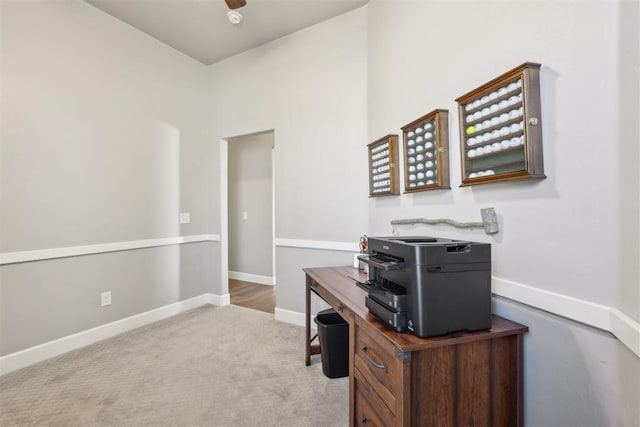 office space featuring a ceiling fan, baseboards, and carpet flooring