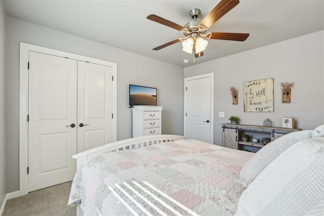 bedroom with a closet, a ceiling fan, and light colored carpet