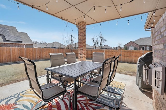 view of patio with outdoor dining area and a fenced backyard