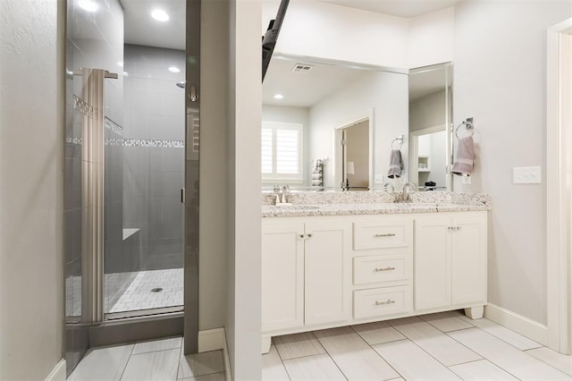 bathroom featuring double vanity, a sink, visible vents, and a shower stall