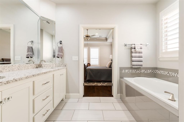 bathroom featuring double vanity, a sink, connected bathroom, tile patterned flooring, and a bath