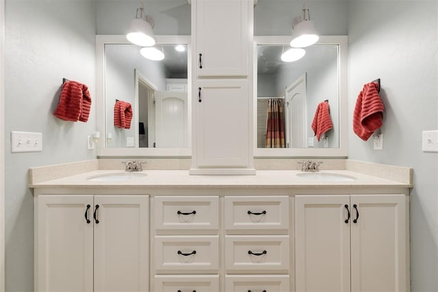 full bathroom with double vanity and a sink