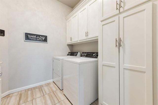 clothes washing area with cabinet space, baseboards, and washing machine and clothes dryer