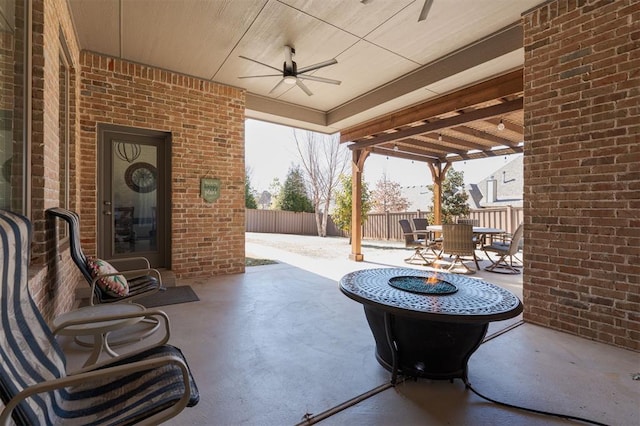 view of patio with a ceiling fan, outdoor dining area, and fence