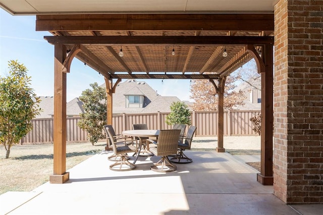 view of patio featuring a fenced backyard, a pergola, and outdoor dining space