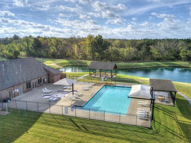 community pool with a water view, fence, a patio, and a yard